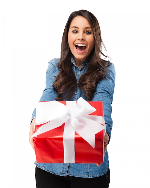 Excited girl holding a gift with a white bow