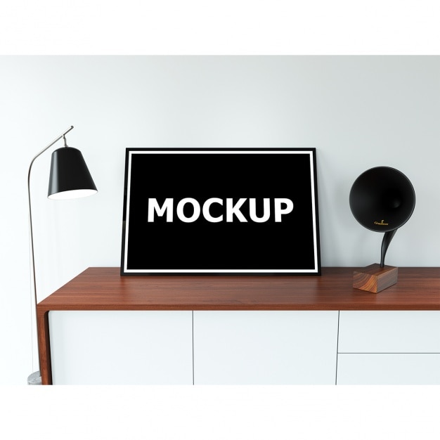 Free PSD frame mockup on table with lamp