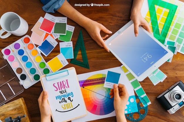 Free PSD graphic designer mockup with hands holding tablet