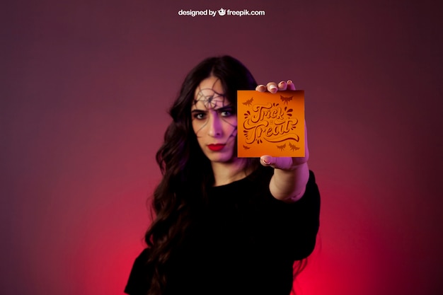 Free PSD halloween mockup with girl holding a card