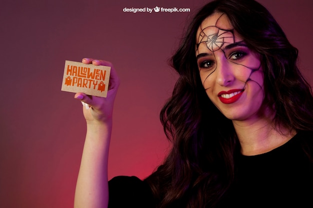 Free PSD halloween mockup with girl showing business card