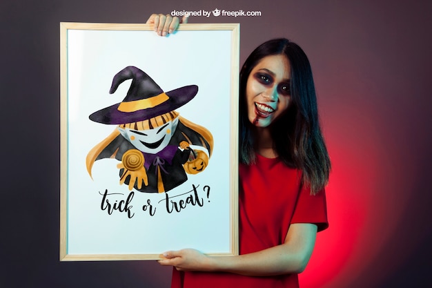 Free PSD halloween mockup with girl showing whiteboard