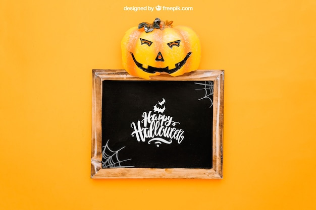 Free PSD halloween mockup with pumpkin op top of slate