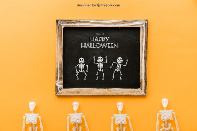 Free PSD halloween slate mockup with four skeletons