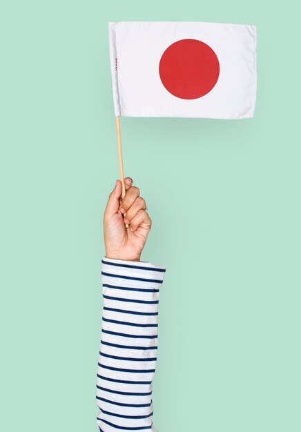 Hand holding japanese flag