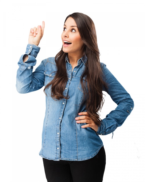 Happy woman pointing with her right hand up