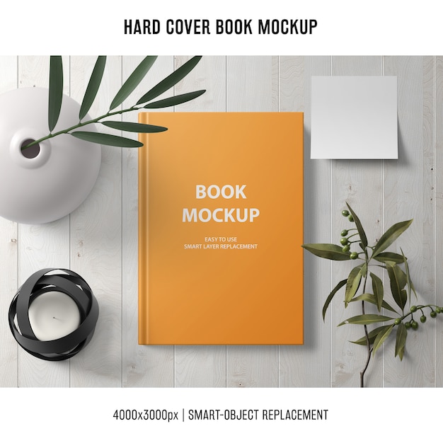 Free PSD hard cover book mockup with plants