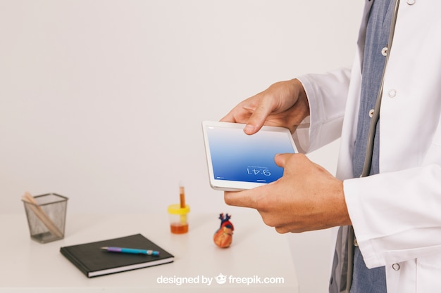 Free PSD medical mock up with doctor working with tablet