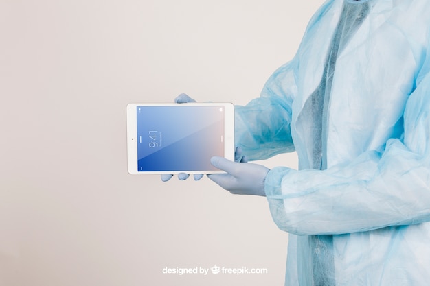 Free PSD mock up with surgeon's hands holding a tablet