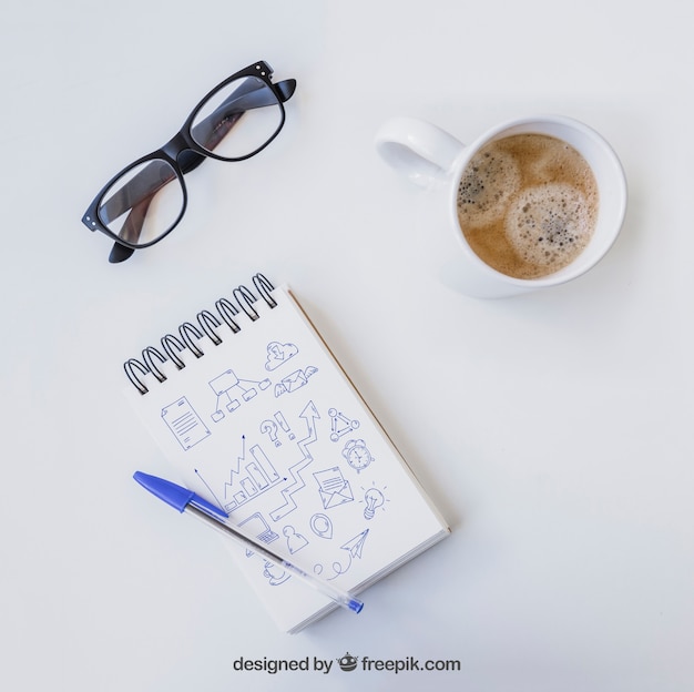 Free PSD notebook with pen, glasses and coffee