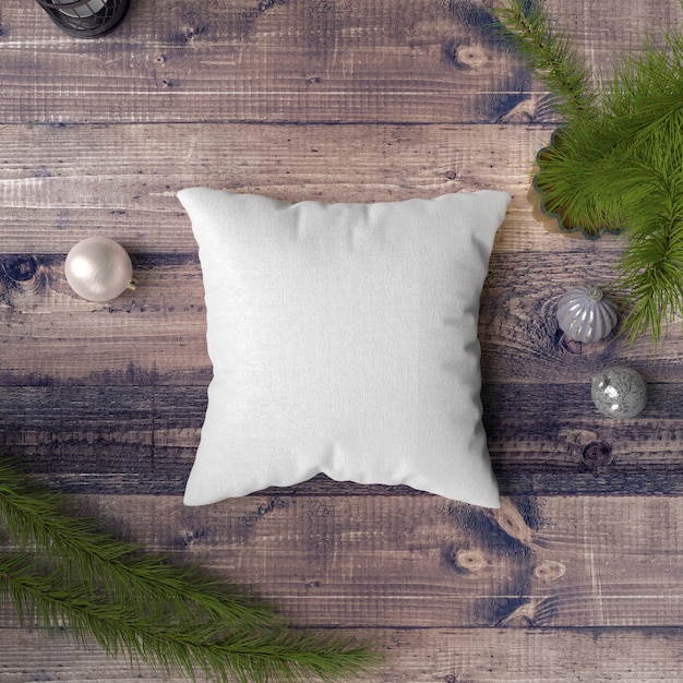 Free PSD pillow on a wooden table surrounded by baubles, pines and fir