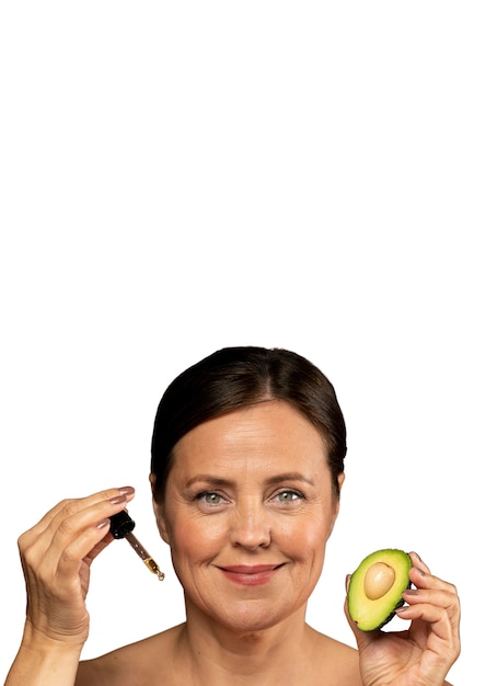 Free PSD portrait of senior woman with avocado for skincare