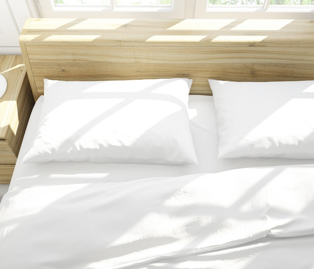 Free PSD realistic white pillows on a double bed