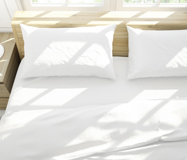 Free PSD realistic white pillows on a double bed