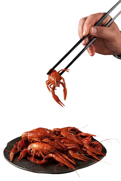 Free PSD view of cooked crawfish held by hand with chopsticks