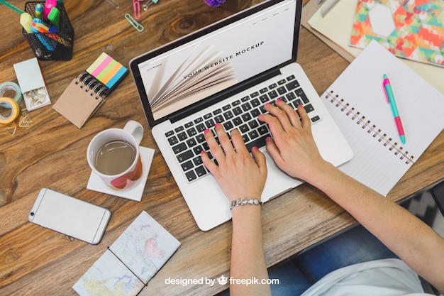 Woman typing on laptop sitting at a desk