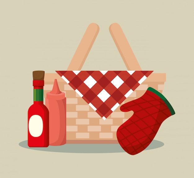 Basket wicker barbecue with bottles and glove