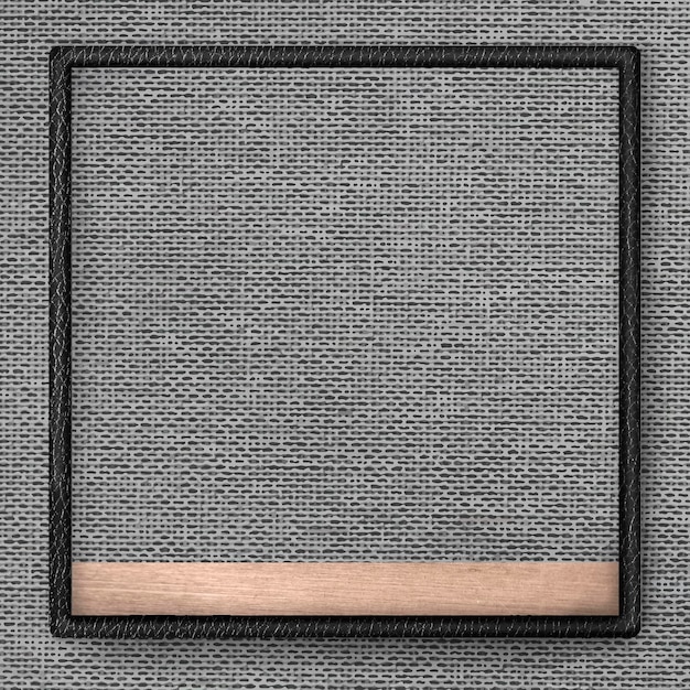 Black leather frame on gray fabric texture background