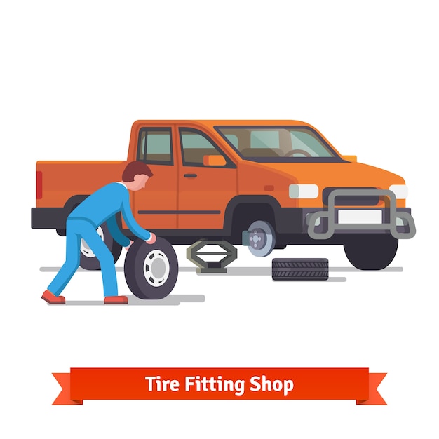 Free Vector car mechanic rolling tire to change it