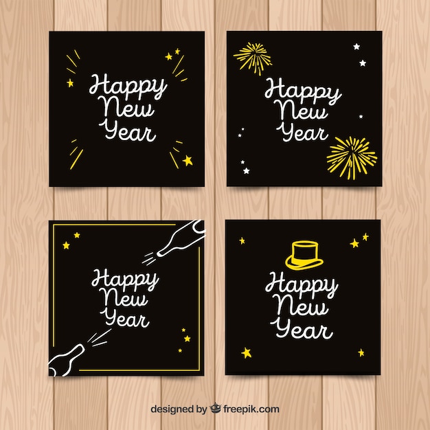 Free Vector collection of four nice hand drawn greeting cards for new year