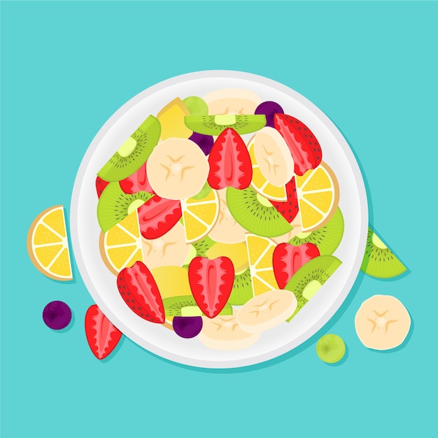 Delicious fruit salad in white bowl top view