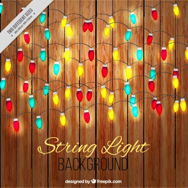 Free vector garland of colored lights on wooden background