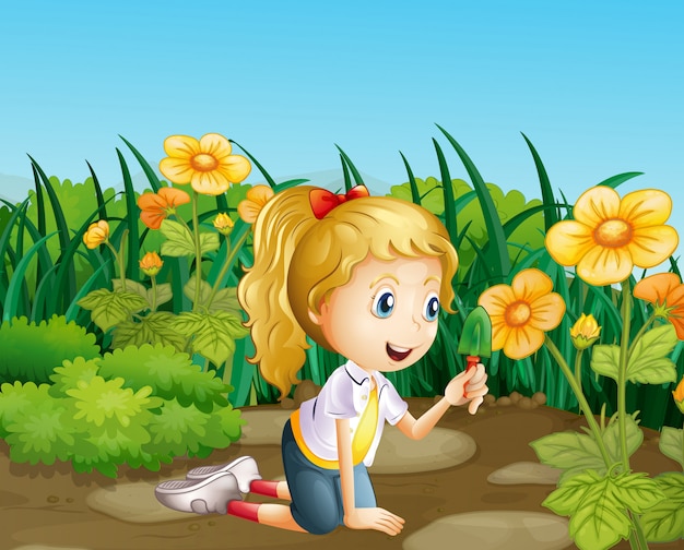 A girl in the garden holding a shovel