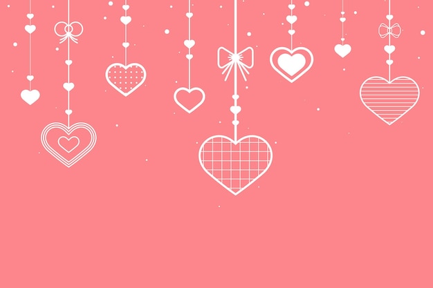 Hanging hearts on pink background