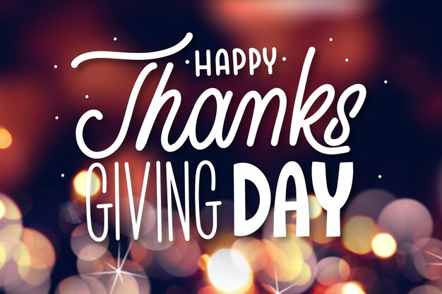 Happy thanksgiving lettering on blurred background