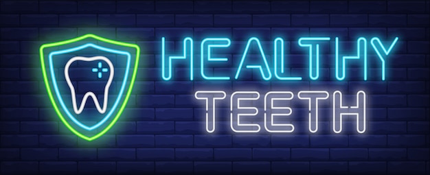 Healthy teeth neon text and tooth with protection shield