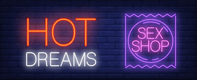 Hot dreams Sex shop neon sign. Purple condom package against brick wall.