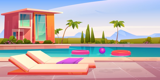 House and swimming pool with deck chairs