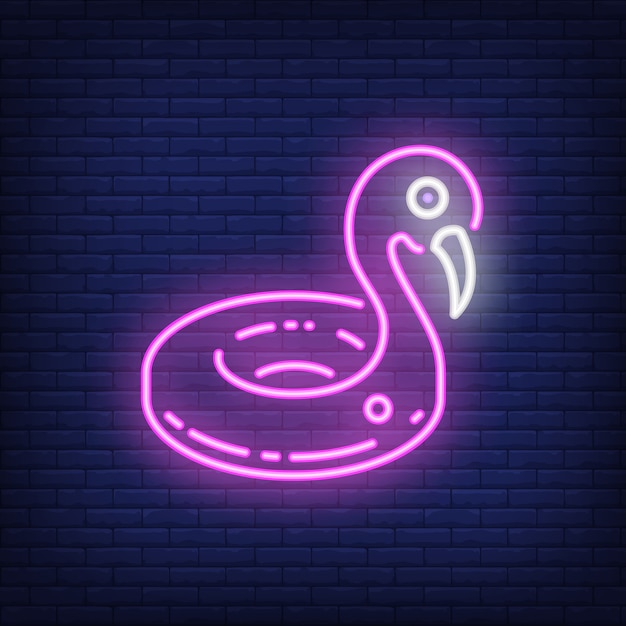 Free Vector inflatable flamingo neon sign. big pink swimming pool toy on dark brick wall background