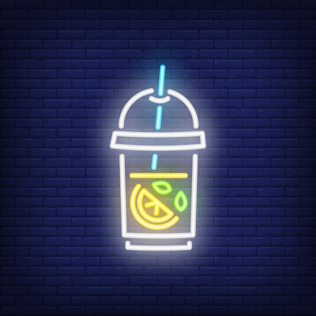 Lemonade neon sign. Glass of iced tea with lemon on dark brick wall background.