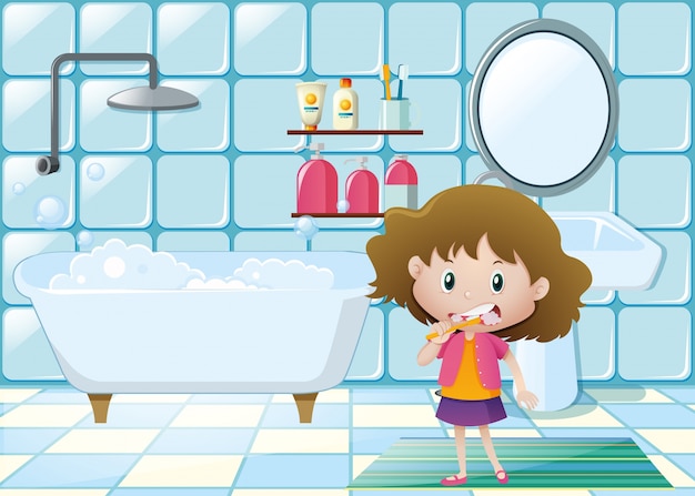 Little girl brushing teeth in bathroom