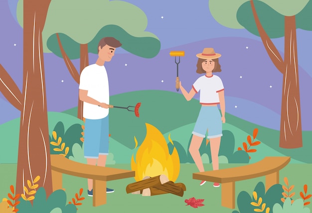 Man and woman in the wood fire with sausage and cob