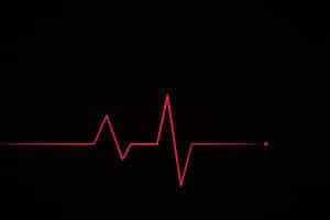 Free vector neon style red heartbeat on dark grid background