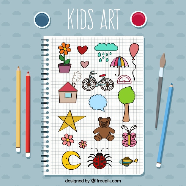 Notebook with kid drawings and pencils