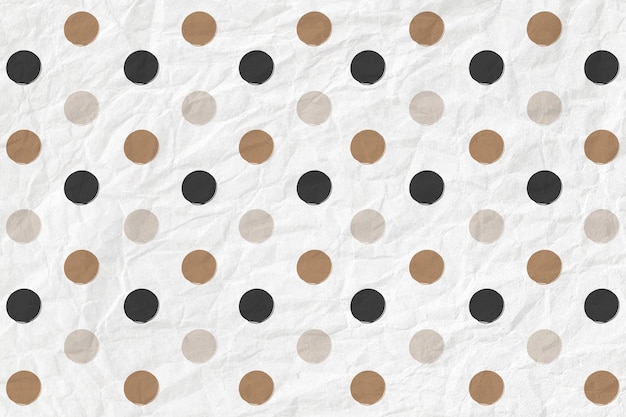 Polka dot pattern in black and gold on crumpled paper textured background