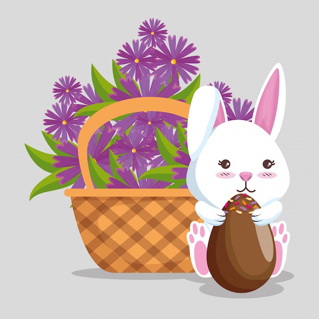 Rabbit with chocolate eggs and flowers inside basket