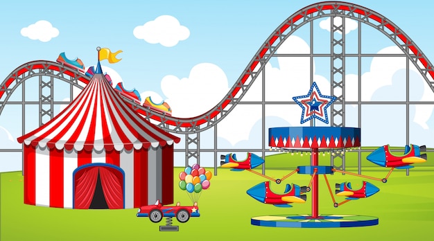 Scene with many rides and circus tent in the fiel