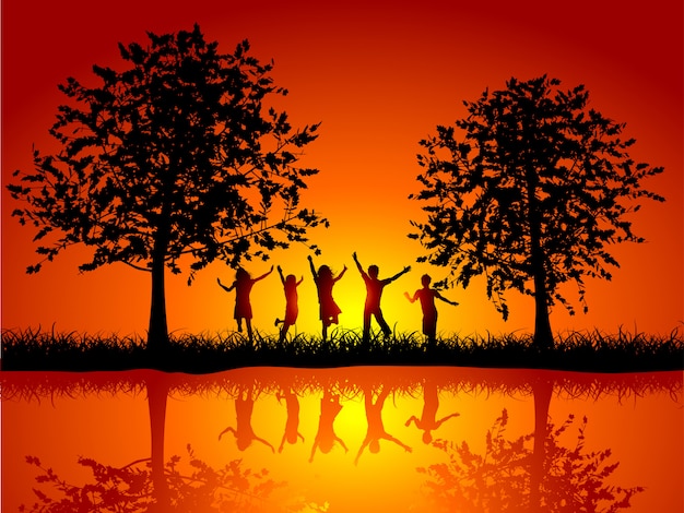 Silhouettes of children playing outside alongside a river