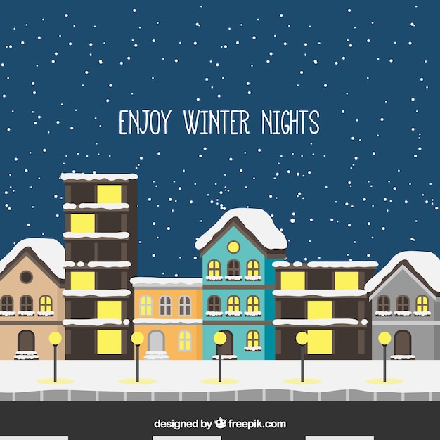 Free vector snowy city background in flat design