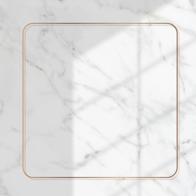 Square gold frame with window shadow on white marble background