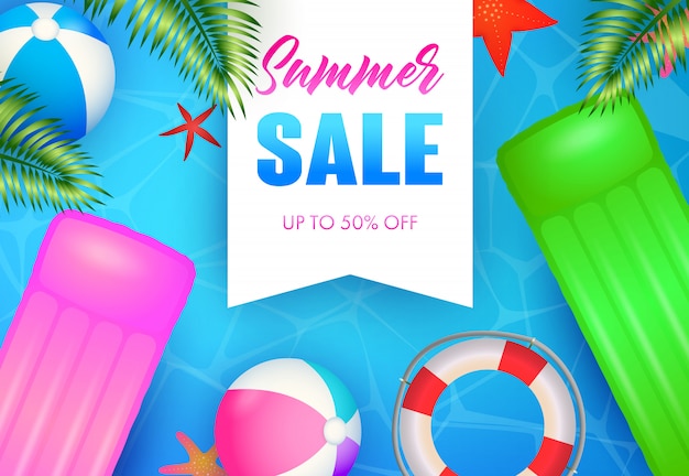 Summer Sale lettering, floating raft, beach balls and lifebuoy