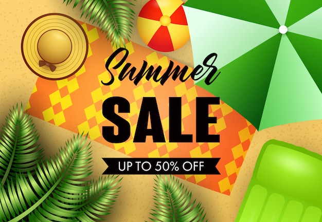 Summer sale lettering with beach mat, hat and umbrella