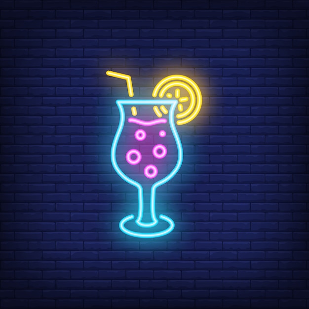 Tropical cocktail neon sign. Fizzy alcohol drink with straw on dark brick wall background