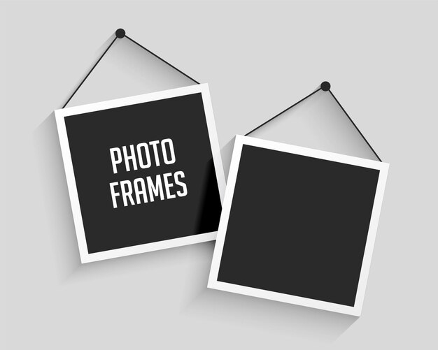 Two blank hanging photo frames background