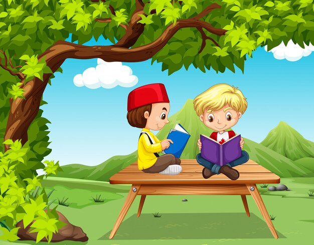 Two boys reading books in the park