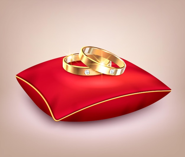 Wedding golden rings with diamonds on red ceremonial pillow